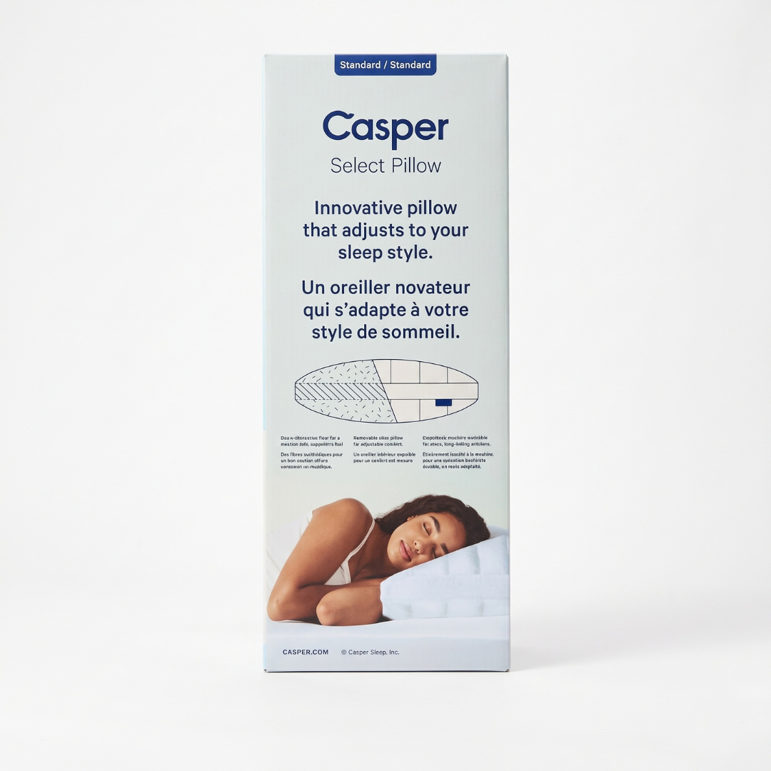 Casper Select Pillow packaging box shown upright on a clean white background. The box features the Casper brand name, product description in English and French, a small product diagram, and a photo of a woman resting on a white pillow near the bottom.