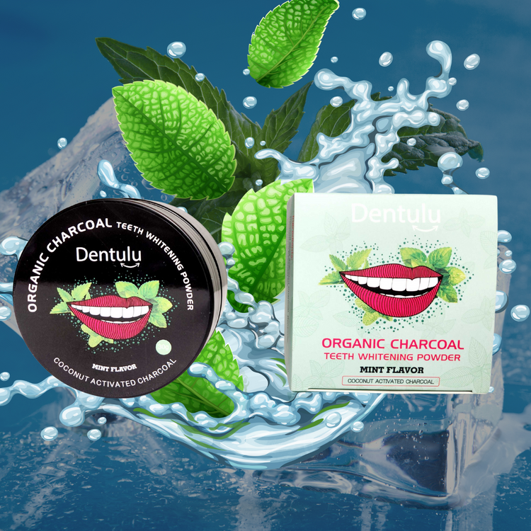 The image shows a product called Dentulu Organic Charcoal Teeth Whitening Powder, with packaging that features a smiling mouth and green leafy design, indicating the mint flavor. There is also an activated charcoal dental whitening product shown with a splash of water and leaves in the background, suggesting the natural ingredients used in the powder.