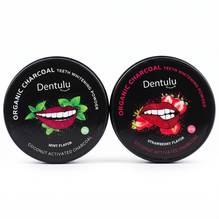 Two black round tins of Dentulu Organic Charcoal Teeth Whitening Powder on a white background, one mint flavor with green mint leaves and one strawberry flavor with red strawberries.